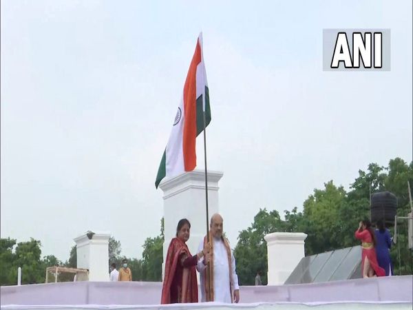 Amit Shah and his wife hoist the tricolour at their residence as the Har Ghar Tiranga campaign begins today