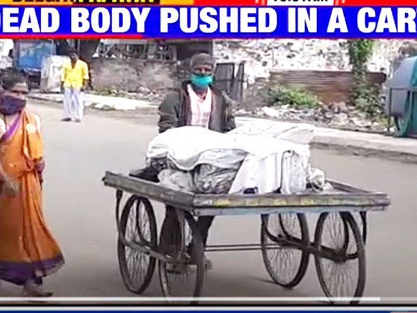 Wife carries man's body on pushcart as kin scramble indoors fearing infection in Belagavi Karnataka