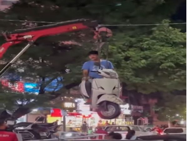 man hanging in the air with scooty watch Viral Video