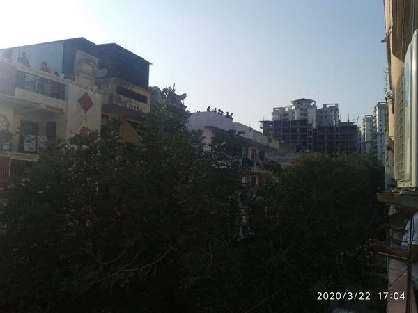 coronavirus people come out on their balconies to clap, clang utensils and ring bells to express their gratitude