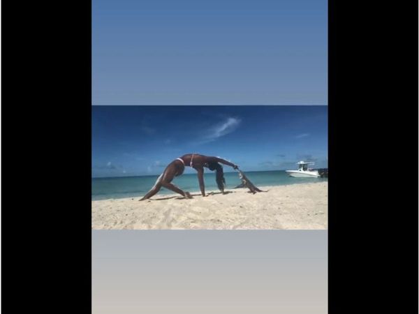 Viral Video Iguana Attack woman while doing yoga on beach video goes viral on social media