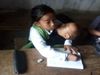 10 Year Old Girl Attends School With Younger Sister in Lap Photo Goes Viral