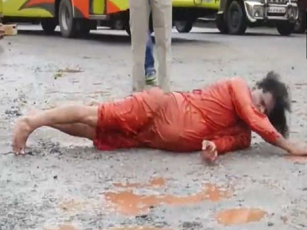 Karnataka A social worker rolls on a stretch of a road as he protests in a unique manner against potholes on the roads