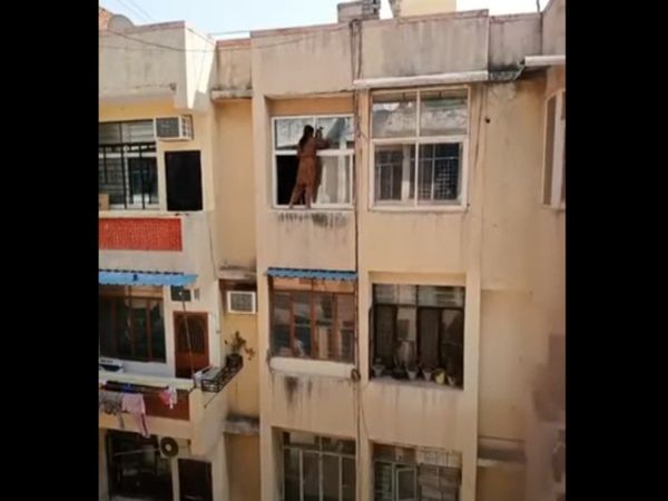 Woman Cleaning Window Glass Hanging From Fourth Floor in Balcony Shocking Video Goes Viral
