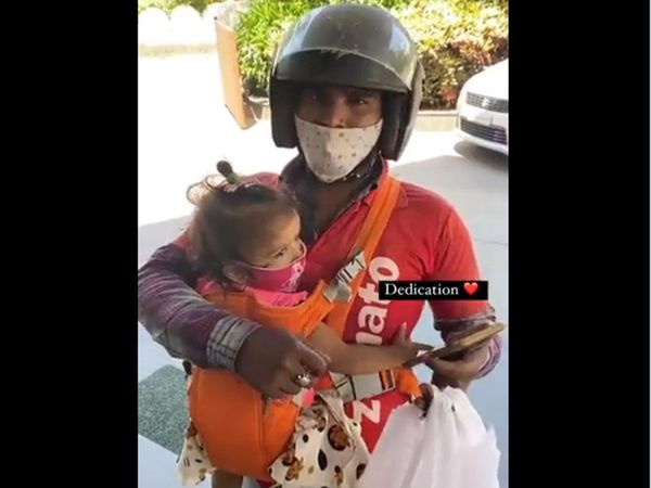Woman delivering food with baby in her lap Video Goes Viral