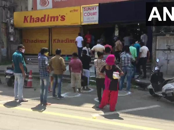 Assam: People line up outside a liquor shop in Dibrugarh 