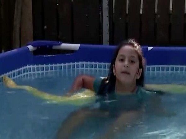 girl swimming with python 