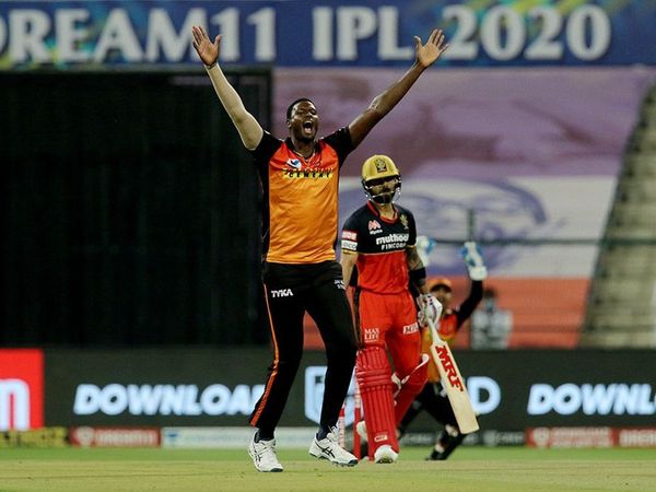 Jason Holder and Virat Kohli