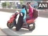 mother on scooty for his son
