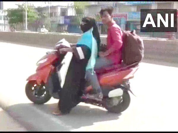 mother on scooty for his son
