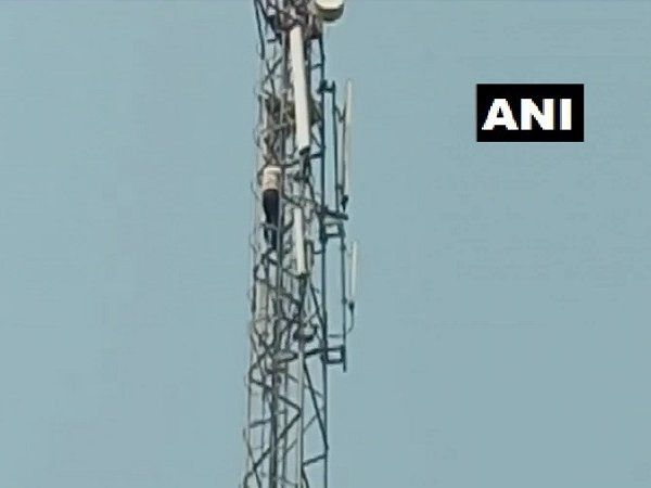 man climbs on mobile tower