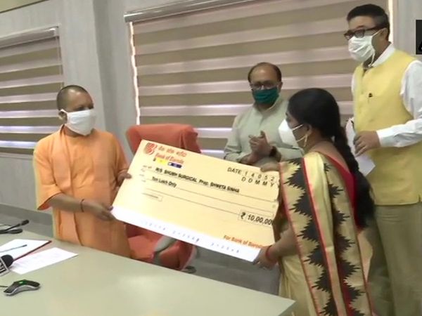 Uttar Pradesh Chief Minister Yogi Adityanath hands over cheques to people involved in MSME 