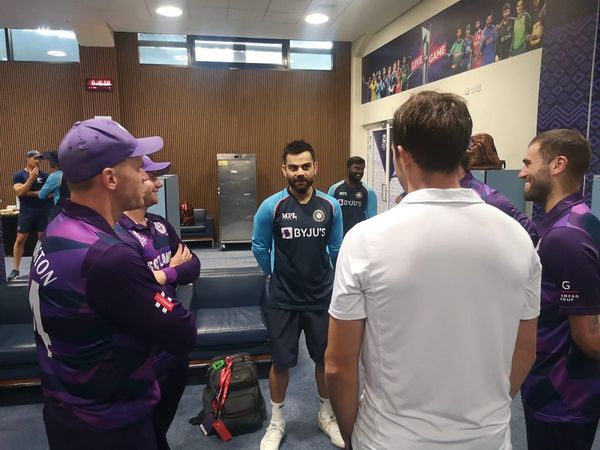 virat kohli interacts with scotland players after the match