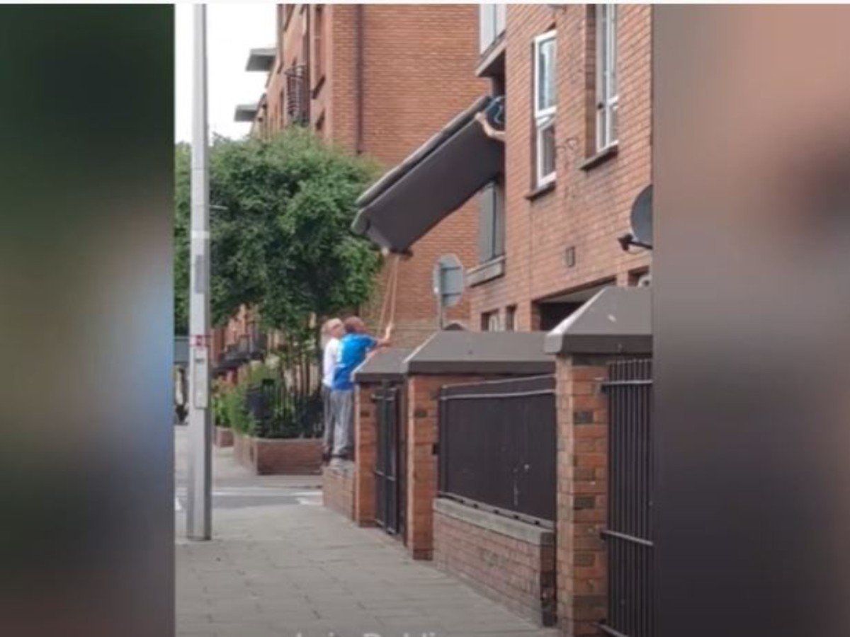 Three men attempt to get sofa out of a window Funny viral video in
