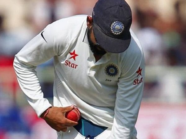 Virat Kohli shining cricket ball