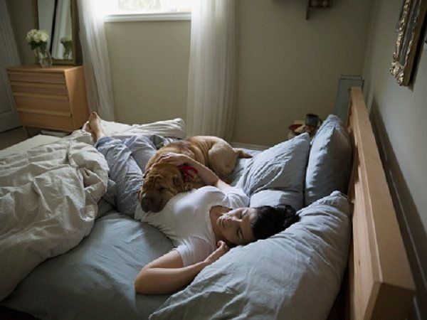 woman sleeping with pet