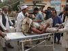 A wounded man is brought by stretcher into a hospital after a mortar was fired by insurgents in Haskamena district of Jalalabad east of Kabul, Afghanistan, Friday, Oct. 18, 2019.